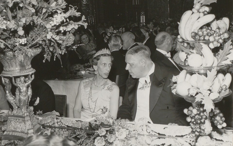 Nobelfest med man och kvinna vid festligt dukat bord. Foto.